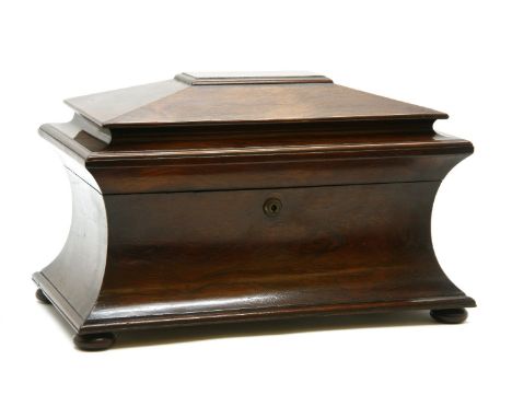 A large Victorian rosewood sarcophagus tea caddy, the shaped top opening to reveal a velvet lined interior, with two tea cont