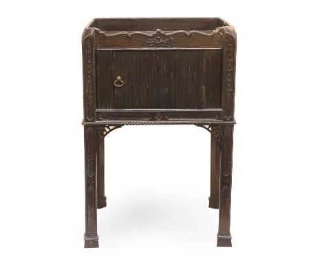 A George III Carved Mahogany Chippendale-Style Bedside Cupboard, 3rd quarter 18th century, the moulded top with pierced carry