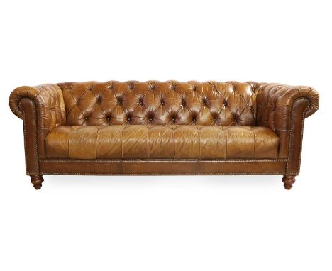 A Chesterfield-Style Three-Seater Sofa, modern, covered in close-nailed button brown leather, on Victorian-style turned legs2