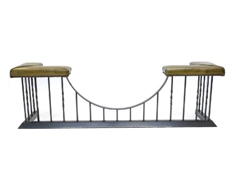 A Victorian-Style Black Metal Club Fender, modern, covered in close-nailed green leather, the padded corner seats above part-
