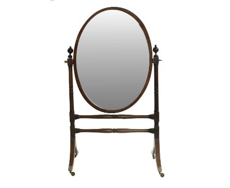 A Late George IV Mahogany Cheval Mirror, 2nd quarter 19th century, the plain oval mirror plate within a moulded frame, on tur