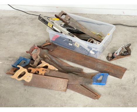 A quantity of vintage saws and other tools. 