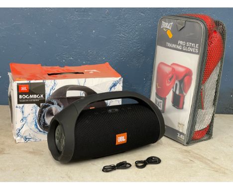 A JBL BOGMBGX portable wireless speaker and Everlast boxing gloves. 
