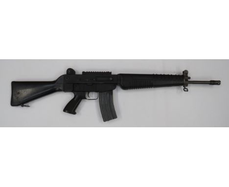 Deactivated Sterling Assault Rifle 5.56 mm, 19 3/4 inch, blackened barrel with front flash hider.  Midway sight with protecti