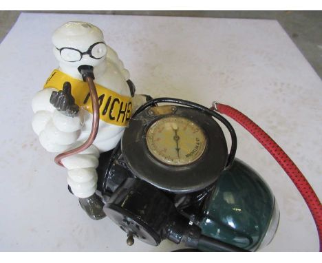 A Vintage Michelin &amp; Co Metal Bodied Tyre Compressor, later painted and modelled as the Michelin Man seated, the pressure