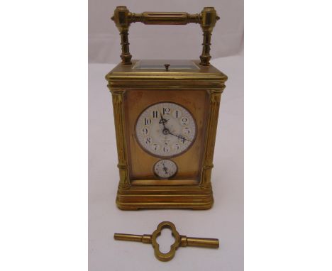 A brass repeating carriage clock by Dent of the Strand, rectangular form with white enamel dial and subsidiary seconds dial, 