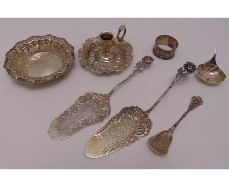 A quantity of hallmarked silver and white metal to include a chamber stick, a bonbon dish, a napkin ring and three servers, a