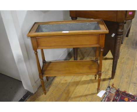 A Continental fruitwood trough jardiniere, c. 1900, raised on slender baluster turned legs joined by a shelf stretcher and fi