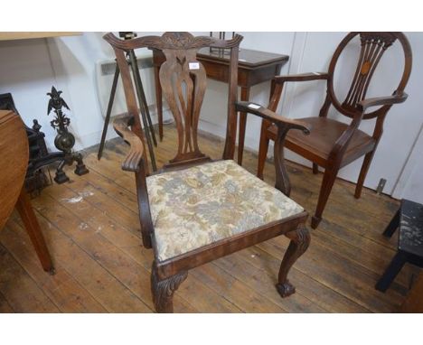 A George III oak provincial open armchair, in the Chippendale style, with pierced vasiform splat above a drop in seat flanked