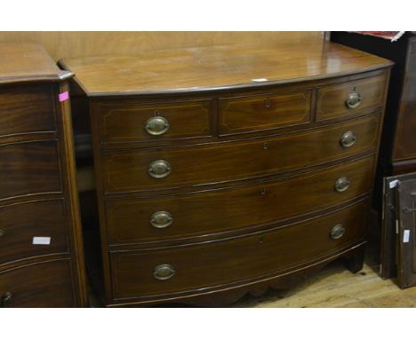 A George III style mahogany bowfronted chest of drawers, with three frieze drawers over three long graduated drawers, on brac