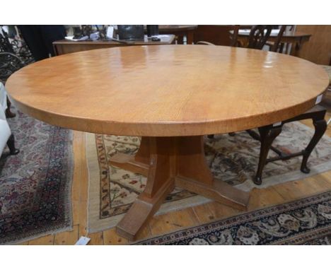 An unusual Robert "Mouseman" Thompson 4'6" circular dining table, c. 1970, the adzed top raised on a cruciform pedestal base 