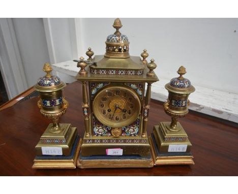 A late 19th century French champleve enamel and brass clock garniture, the dial with Arabic numerals on a gilt chapter ring w