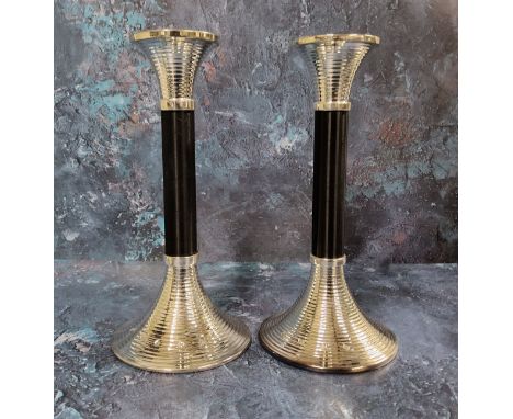 A pair of Art Deco style candlesticks, ribbed flared nozzle, ebonised column, conforming flared base,&nbsp;23.5cms high, Jame