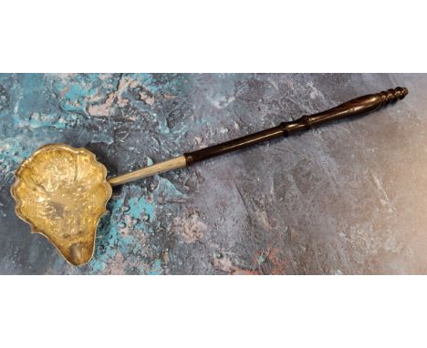 A George III toddy ladle, the bowl embossed with leaves and foliage, turned handle, 33cm long, London 1810 