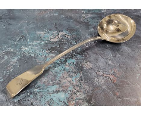 A George IV silver fiddle back ladle, dragon crest,&nbsp;Clement Cheese, London, 1829, 34cms 209g 