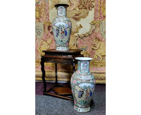 A pair of Canton Famille Rose vases, polychrome decorated with a border of chrysanthemums, roses, birds and butterflies with 