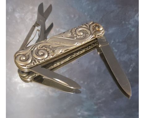 An early 20th century Norwegian silver pocket knife, the case boldly embossed with scrolling foliage, with folding scissors, 