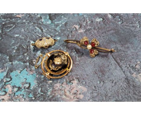 A late 18th/early 19th century yellow metal diamond &amp; enamel brooch, the central blue enamelled 'cabochon' inlaid with a 