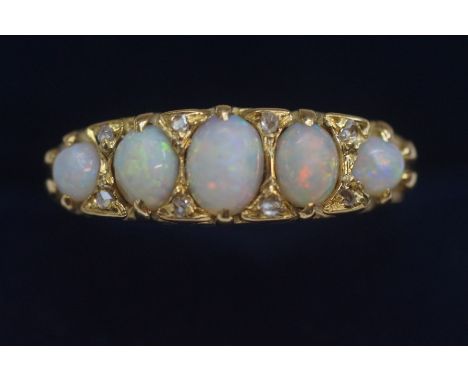 18ct Gold ring set with 5 opals inset with diamonds. Size P