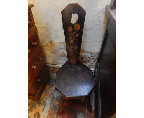 A 19th century spinning chair, the stick back pierced the a heart above a solid seat with penwork decoration. 