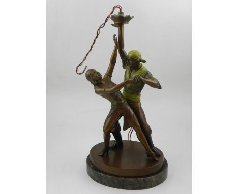 An Art Deco style spelter table lamp, modelled in the form of dancing gypsy's, raised on a marble base, H. 30cm 