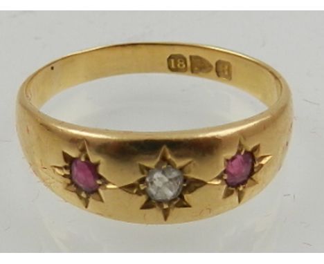 An 18 carat yellow gold, diamond, and ruby set gypsy style gent's ring. 