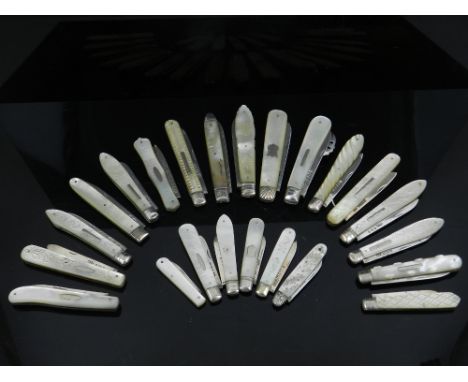 Twenty three silver hallmarked folding fruit knives all with mother of pearl scales, variously carved, engraved and plain, mo