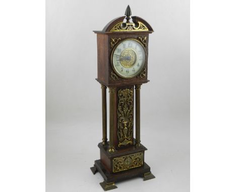 An early 20th mantel timepiece, in the form of a miniature longcase, the enamel chapter ring with Arabic numerals, the oak ca