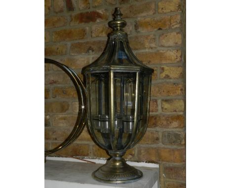 An octagonal gilt metal glazed lantern, the interior hung five tea light holders, H:75cm