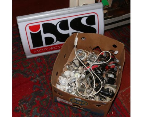 A light up sign box advertising IXS Motorcycle Fashion, along with a collection of light fittings.