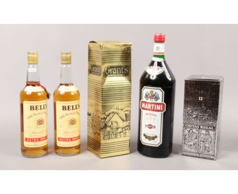 A good collection of sealed spirits; two 75cl Bells extra special, Old Scotch Whisky, a 150cl Martina Rosso, along with a box