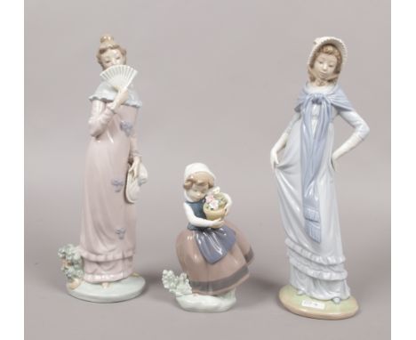 Two Nao figures of young girls along with a Lladro figure of a child holding a potted plant.Condition report intended as a gu