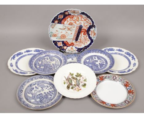 A collection of pottery and porcelain plates including a Japanese Imari dish, blue and white, Alfred Meakin etc.