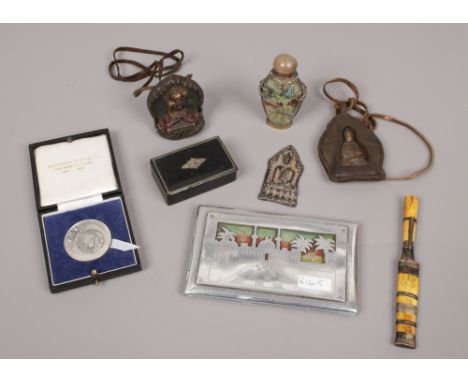 A mixed lot of collectables including three Buddhist amulets, modern Chinese glass snuff bottle painted inside out, Georgian 