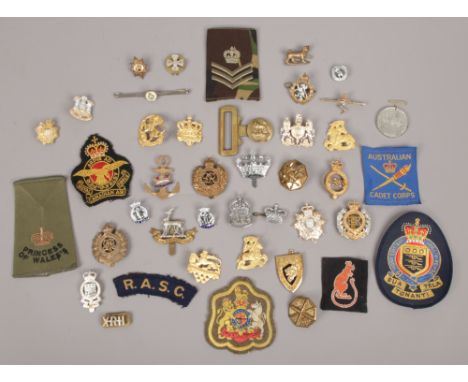 A collection of military badges to include A. R. P Royal Navy, Royal Engineers, Air Training Corps etc.