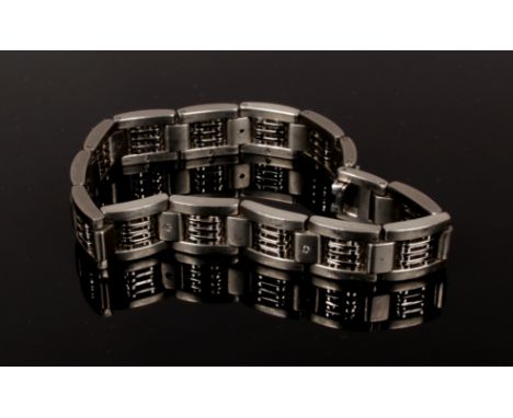 A titanium gate bracelet set with seven small diamonds.