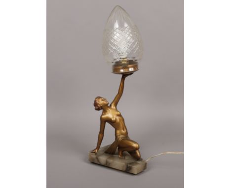 An Art Deco figural spelter table lamp formed as a semi naked girl with clear glass shade c.1930.Condition report intended as