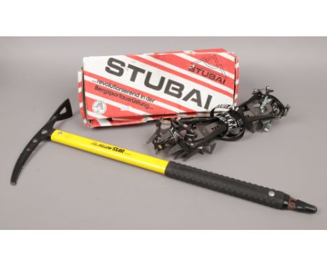 A Stubai yellow star ice axe and boxed pair of Stubai flexi walking crampons.