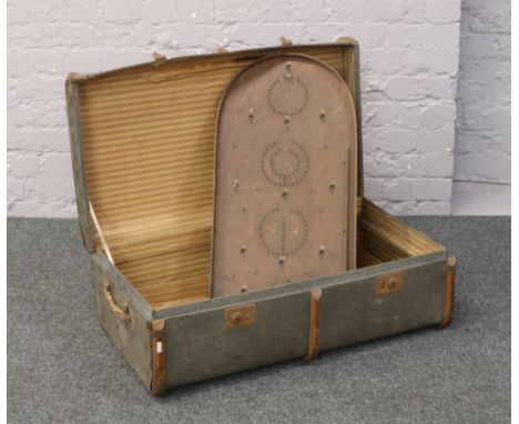 A wood bound travel trunk with rope handles and a bagatelle board.