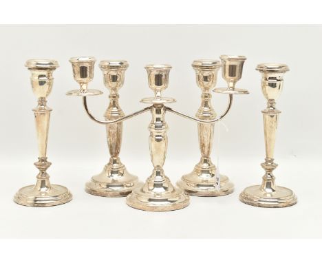 TWO PAIRS OF ELIZABETH II SILVER CANDLESTICKS AND AN ELIZABETH II THREE LIGHT CANDELABRUM, all of a similar style with taperi