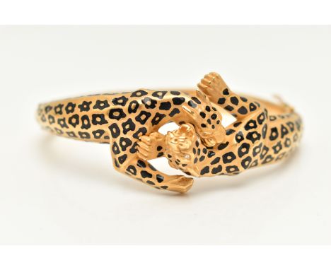 A 'CARRERA Y CARRERA' BRACELET, a Spanish, yellow metal hinged bangle, depicting two leopards, round brilliant cut diamonds t