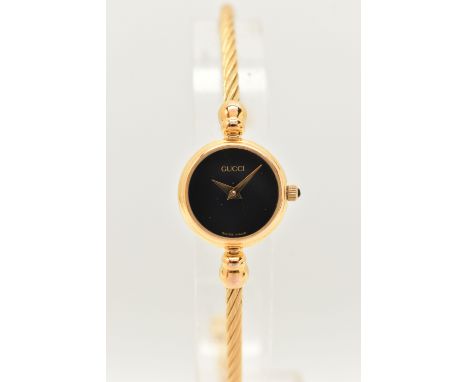 A LADIES 'GUCCI' WRISTWATCH, quartz movement, round black dial, signed 'Gucci', gold plated case, approximate case width 18mm