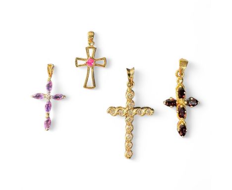 A group of four crosses, three are marked '375', the example with the amethysts is unmarked, one example with garnets and the
