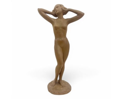 An unusual Art Deco Goldscheider brown terracotta-type figurine of a confidently posed slim naked lady with her arms raised a