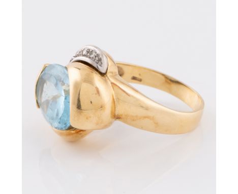 An 18ct yellow gold ring set with a facet cut oval aquamarine and a white gold curving arm set with four small diamonds, the 