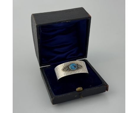 A sterling silver napkin ring by Bernard Instone (1891-1987), Birmingham 1925, with hammed finish with detailed wirework and 
