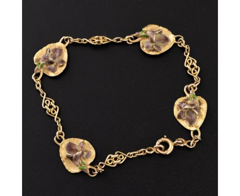 An 18ct gold and enamel bracelet c.1900, with four veined leaves supporting gold and flowers enamelled in lilac and green, th