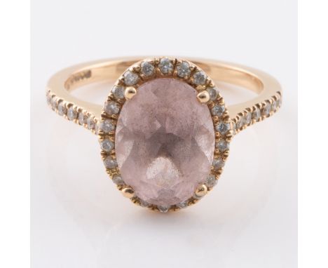 An 18ct gold ring with diamonds on the shoulder and pink stone (probably morganite) set within a ring diamonds, ring size H, 