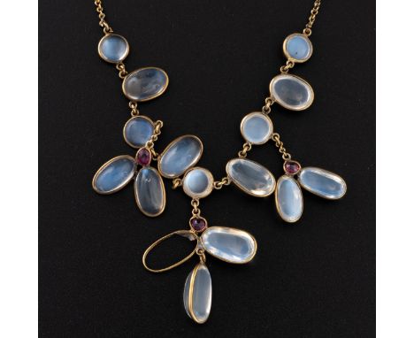 A c.1900 gold and moonstone necklace, with circular and ovoid moonstones set along chain, the three drops with more length of