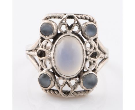 An Arts and Crafts silver ring with moonstones, with an openwork shield-shaped outline, the wirework is set within a rope pat